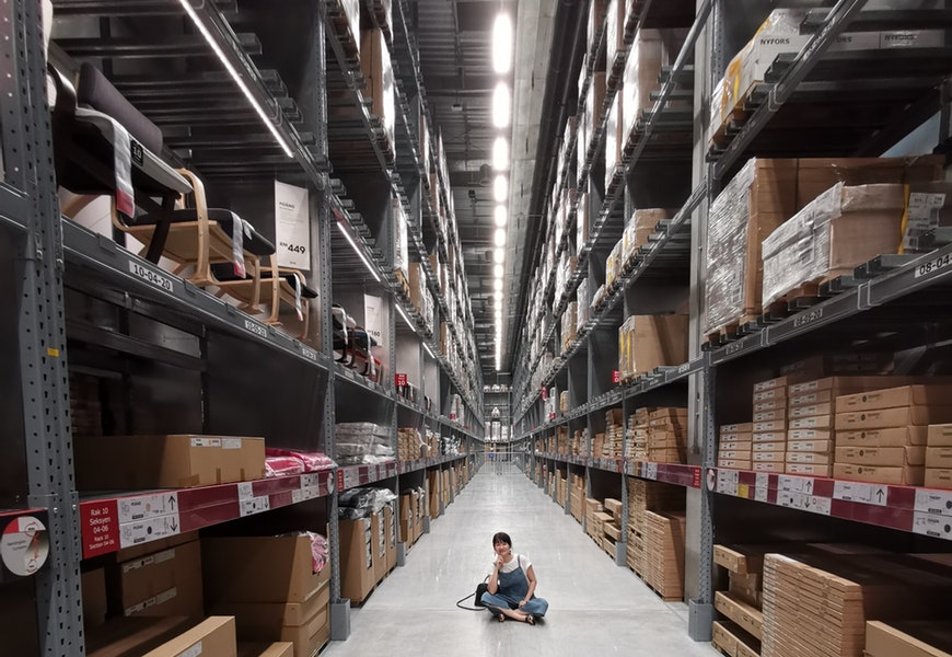 person-sitting-on-ground-between-brown-cardboard-boxes-2701434